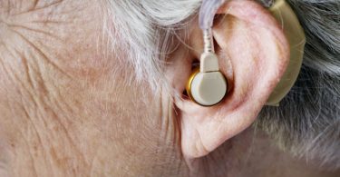 Elderly woman wearing a hearing aid