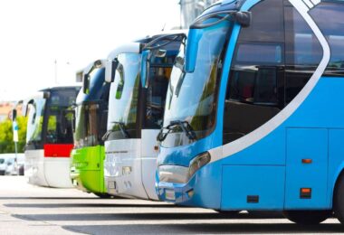 A lineup of modern coaches in various colours parked side by side, illustrating transportation options for sports teams, emphasising safety and style for team travel.