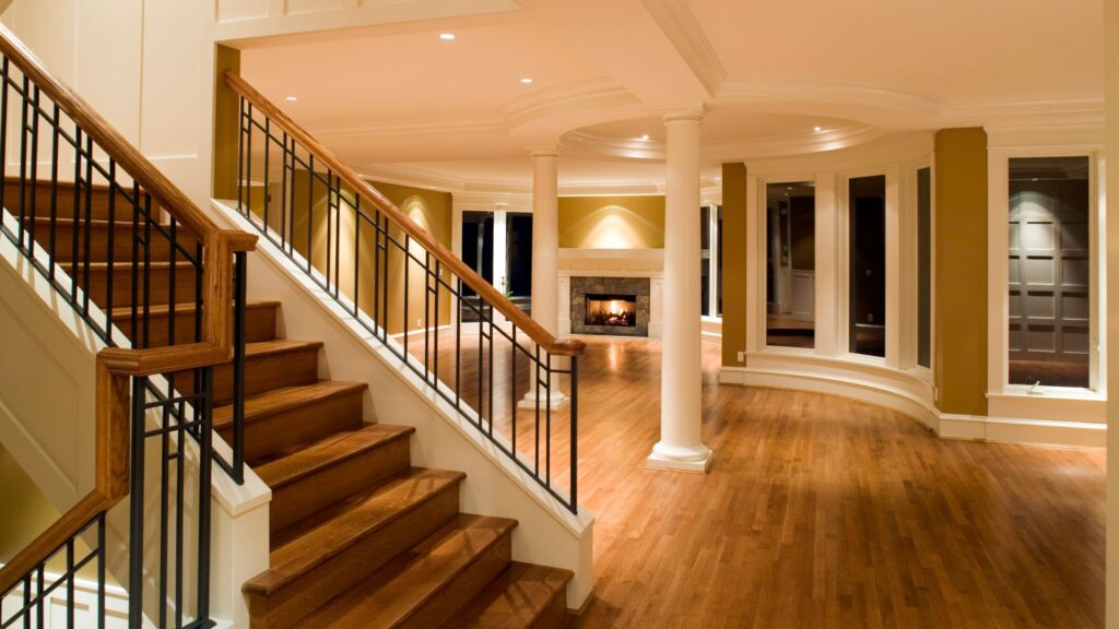 Luxurious home interior with wooden staircase and hardwood flooring, highlighting different flooring options for residential spaces.