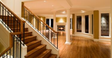 Luxurious home interior with wooden staircase and hardwood flooring, highlighting different flooring options for residential spaces.