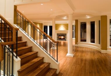 Luxurious home interior with wooden staircase and hardwood flooring, highlighting different flooring options for residential spaces.